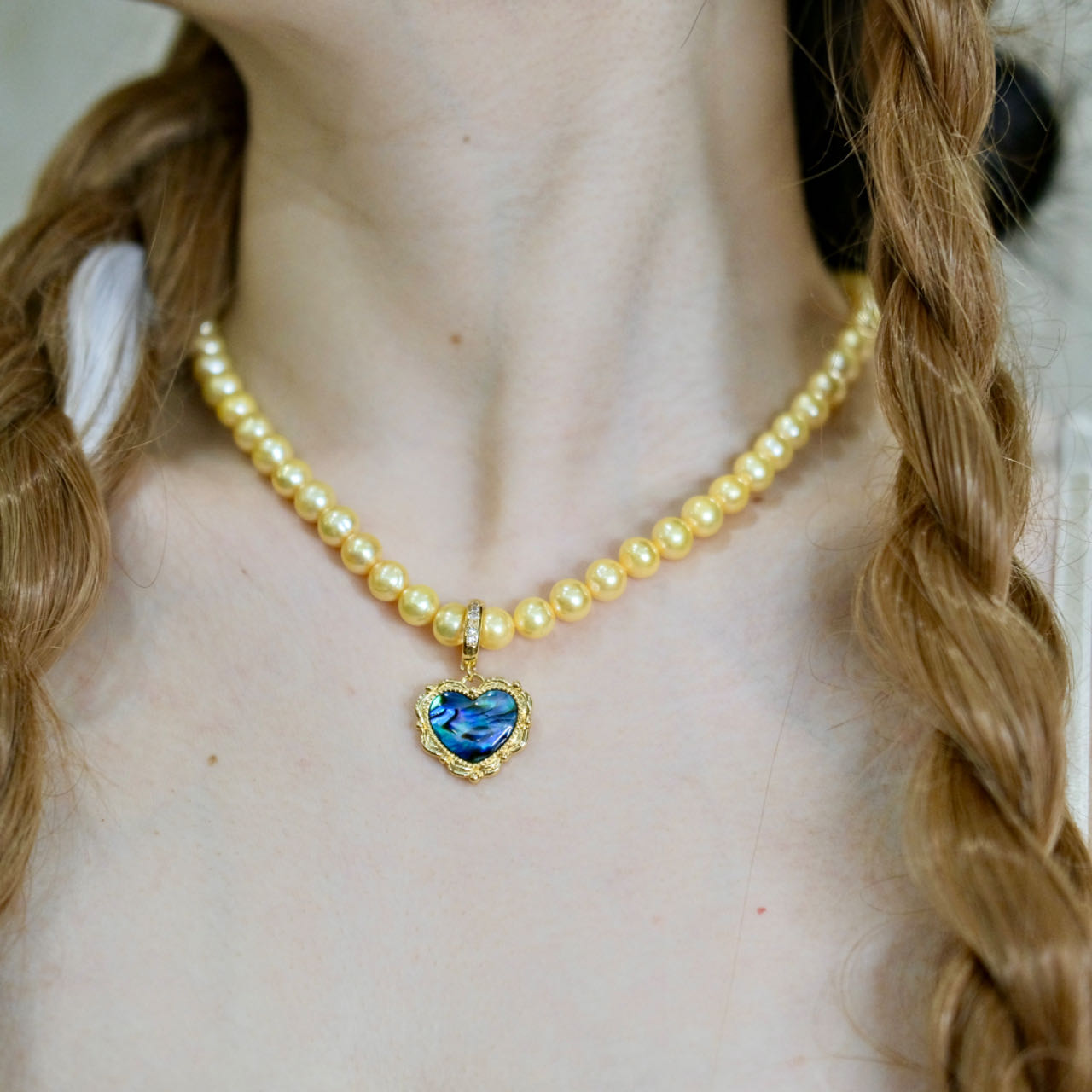 Yellow colored pearls necklace with mother of pearls heart pendant