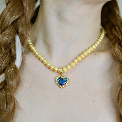 Yellow colored pearls necklace with mother of pearls heart pendant