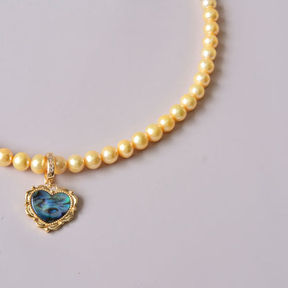 Yellow colored pearls necklace with mother of pearls heart pendant