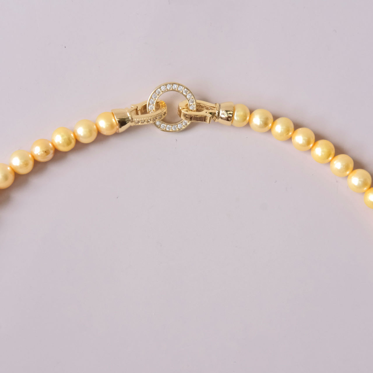 Yellow colored pearls necklace with mother of pearls heart pendant