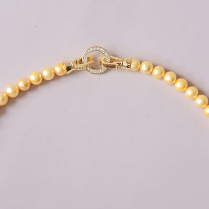 Yellow colored pearls necklace with mother of pearls heart pendant