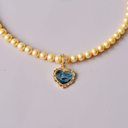 Yellow colored pearls necklace with mother of pearls heart pendant