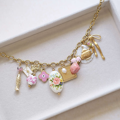 Vintage Charm Necklace - Gold Chain with Floral, Fish & Tea Accents